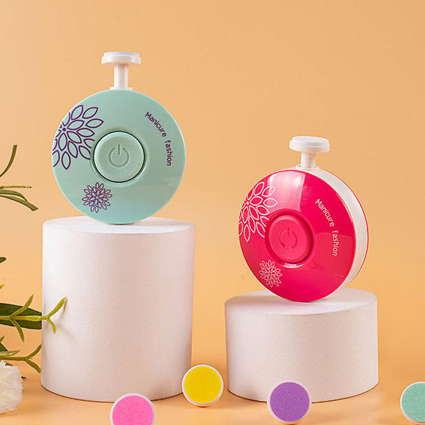 Two nail sanding devices on white stands with a blurred background