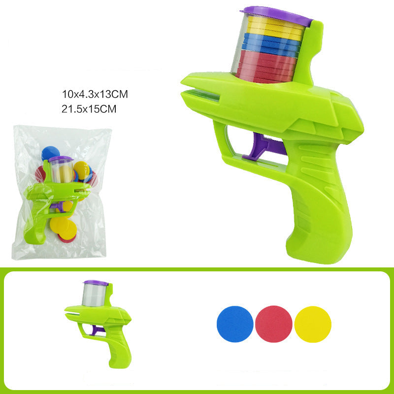 Toy gun with colorful discs and packaging on a white background