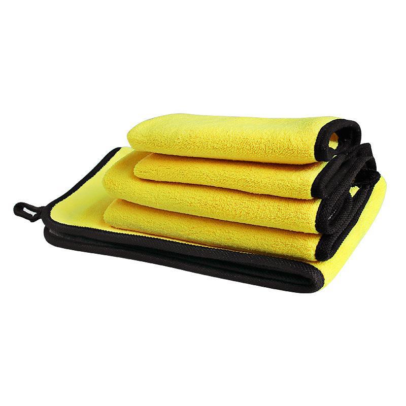 Yellow microfiber towels with black edges on a white background
