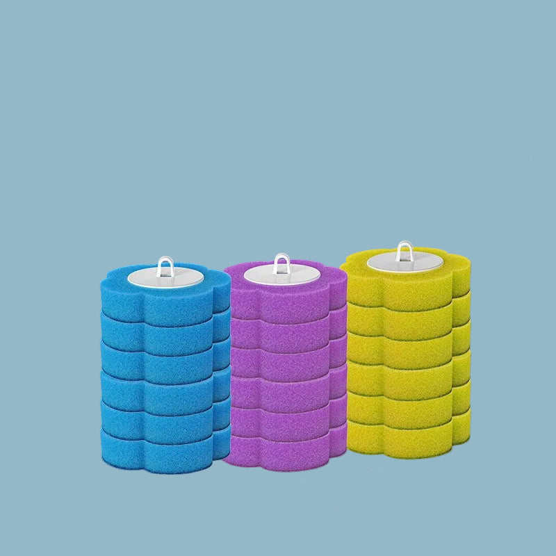 Three floral shape cleaning brushes in blue, purple, and yellow on a blue background.