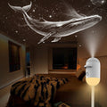 Room with a whale-shaped ceiling projection and a small night light device.